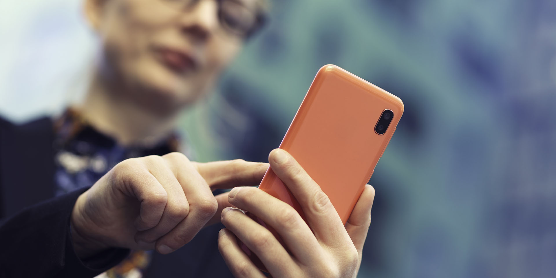 Close up image of a woman using a smart phone, with focus on the phone